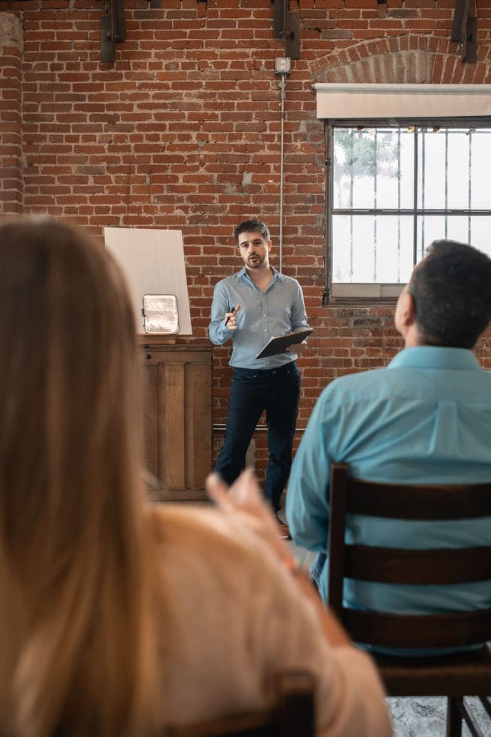 Man Discussing in Front of a Class