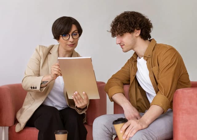 A woman showing a tablet to a man during a professional conversation