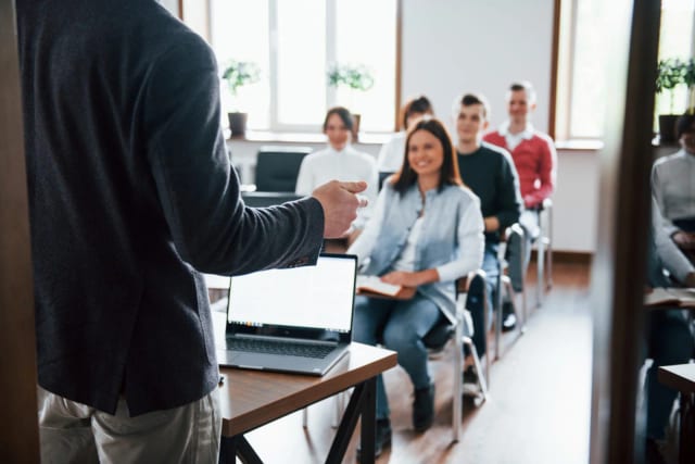 A professional applies communication skills during a real presentation